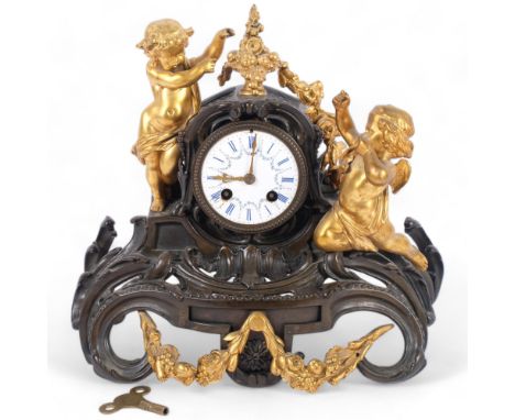 A Victorian Rococo style bronzed and gilt-metal mantel clock, with enamel dial, decorative cherub supports, H29cm 