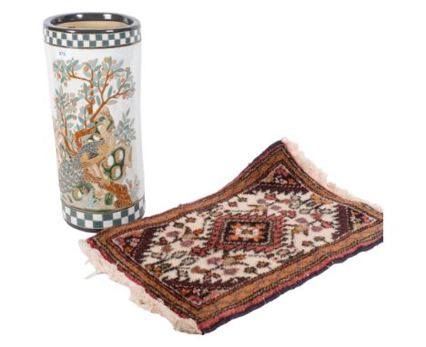 An Oriental stick stand with enamelled bird and blossom decoration, H45cm, and a small woollen rug 