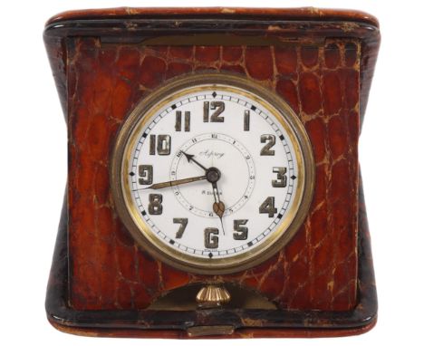 ASPREY - an early 20th century Asprey's travelling alarm clock, 8-day movement with white enamel dial, and a snakeskin covere