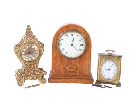 An Edwardian oak 8-day mantel clock, a Swiza 8-day clock, and a gilt-metal mantel clock with enamelled panels and Roman numer