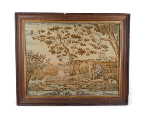 An Antique French handmade tapestry, landscape scene, cows grazing in a field, church buildings in background, framed, 85cm x
