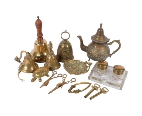 4 brass bells, embossed brass teapot, H23cm, a glass desk stand, nutcracker, candle snuffers, etc 