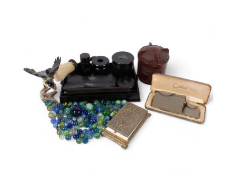 An ebony dressing table set, Colibri boxed lighter, Bakelite box, Goebels Great Tit, marbles, and desk-top brass notepad hold