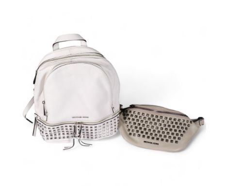 A Michael Kors light grey leather bumbag, with metal studded detail, and a Michael Kors white leather backpack, with metal st