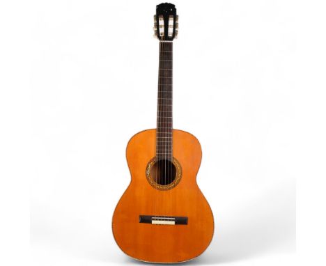 A Vintage Romy Lumanog acoustic guitar, with inlaid decoration 