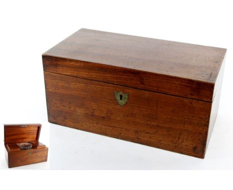 A 19th Century mahogany tea caddy
Of typical rectangular form with brass inlaid heraldic escutcheon, the hinged cover reveali