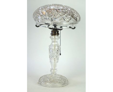 A cut glass mushroom lamp, circa 1920
The domed circular base rising to a tapered and knopped stem, the dome glass shade rest