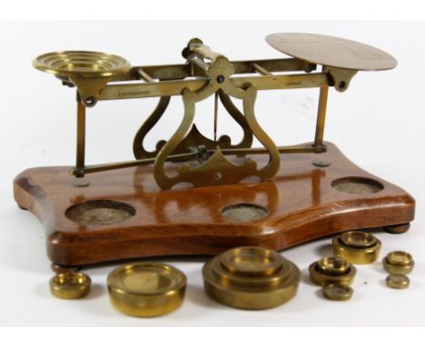 A pair of Victorian mahogany and brass mounted S. Mordon & Co postal scales
The cast lever balance scales inscribed with rate