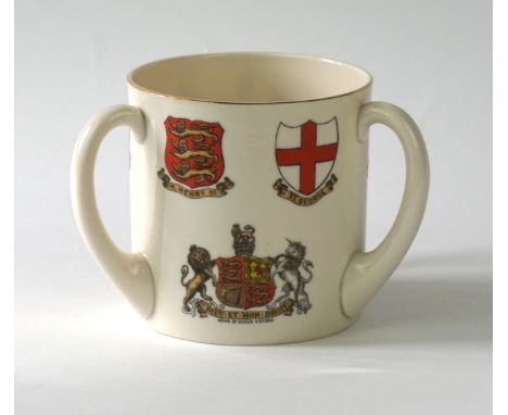 A large W. H. Goss tyg
Of typical cylindrical form, applied with three loop handles, painted to the exterior sides with heral