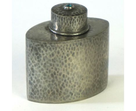 An Arts & Crafts English pewter tea caddy 
Of oval form, made by Liberty & Co, the cover having central turquoise cabochon ab