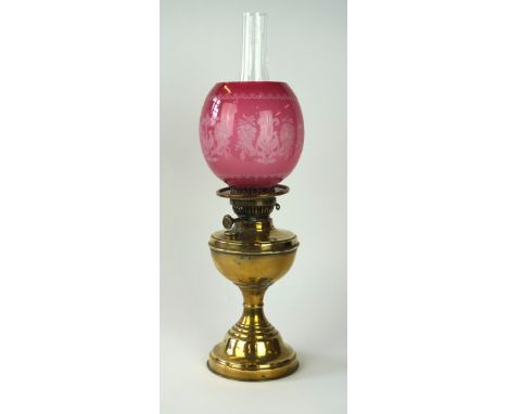 An early 20th Century National Lampworks oil lamp
The stepped brass base rising to a sloped ovoid oil receptacle, extending t