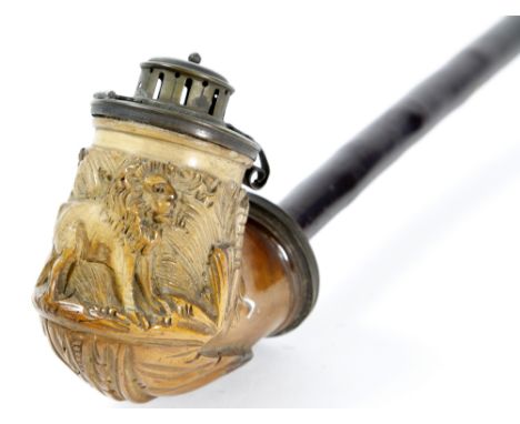 A Middle Eastern hookah type pipe
The carved and turned pipe section extending to a carved bowl with lion and foliate landsca