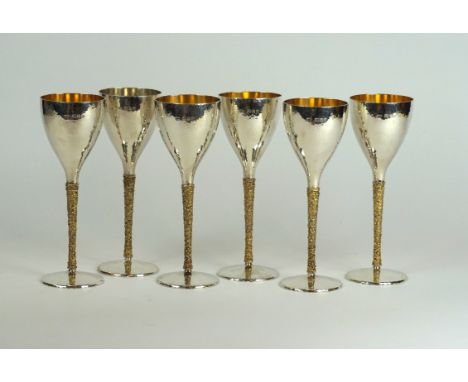 Stuart Devlin (b.1931) - A set of six contemporary hallmarked silver and parcel gilt 'Totum' goblets
The bowls and stems havi