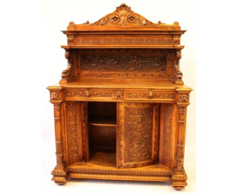 A good quality Victorian oak side cupboard in the Flemish taste
The whole profusely carved in bold relief with dragon masks, 