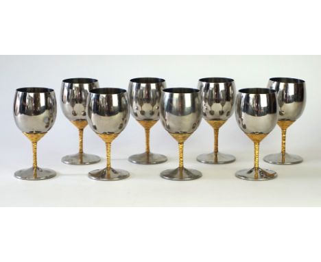 Stuart Devlin (b.1931) - a set of eight stainless steel and gilt hock glasses
The bowls of plain form modelled with gilt text