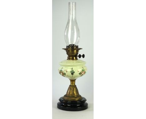 A late 19th/early 20th Century oil lamp
The ceramic black glazed stepped socle base rising to a gilt metal pedestal stem into