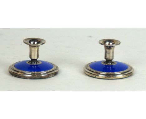 A pair of sterling silver and blue guilloche enamelled candlesticks 
Of circular squat form, impressed marks to rim, height 5