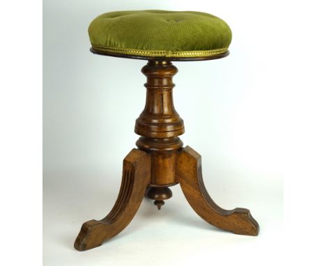 A Victorian light oak circular topped piano stool
Raised on a brass adjustable column, terminating on three carved oak legs.