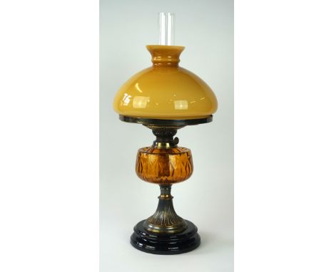 An early 20th Century oil lamp
The black glazed stepped ceramic base extending to a cast metal acanthus swept pedestal stem, 