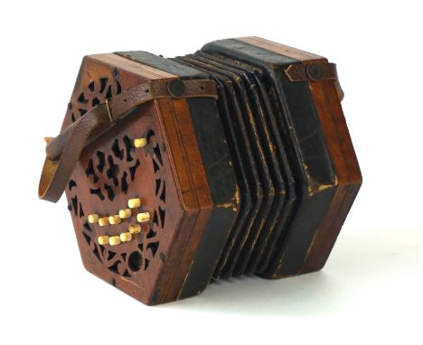 A Lachenal & Co concertina, circa 1890
The twenty one button concertina with pierced foliate mahogany ends and leather straps