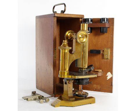 An early 20th century mahogany cased R & J Beck brass microscope
Model no. 26873, complete with assorted lenses.
