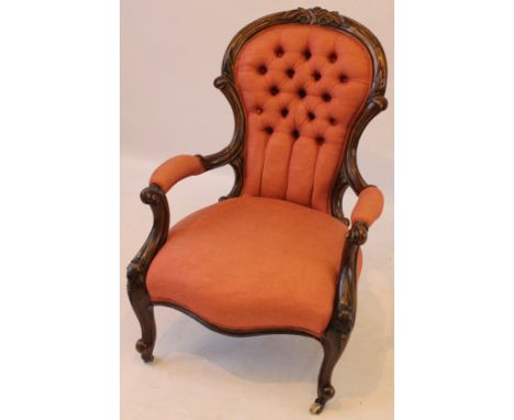 A Victorian carved mahogany 'show wood' framed open-sided armchair
The button back, arm pads and generous seat, all reupholst