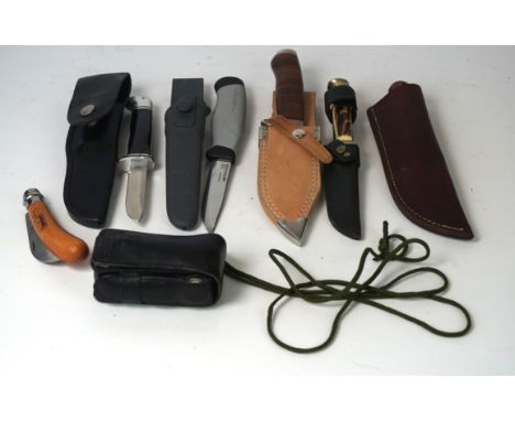 A modern Swiss army pen knife
Comprising corkscrew, scissors etc housed in a leather belt pack, plus six further survival kni