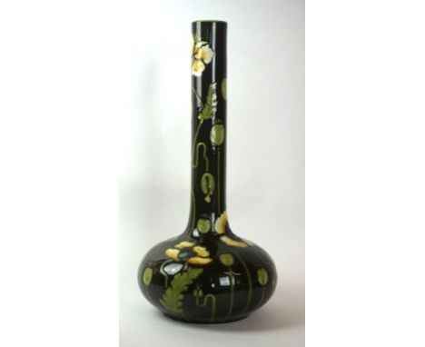A circa 1900 Aesthetic Movement ceramic vase
Of bulbous form, with an elongated cylindrical neck, having tubeline and incised