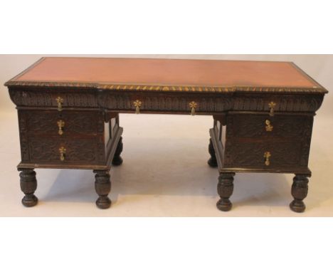 A Victorian carved oak kneehole desk, in the 17th Century taste
The rectangular top with gadrooned border and inset leather w