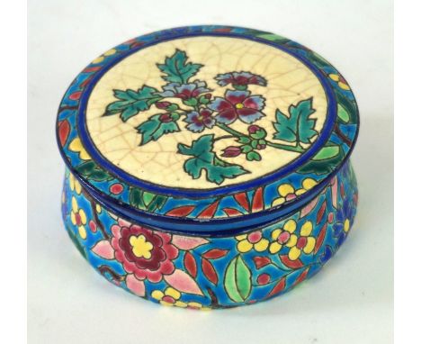 A Longwy French faience ware circular trinket pot and cover
Painted in enamel with floral decoration on a white and turquoise