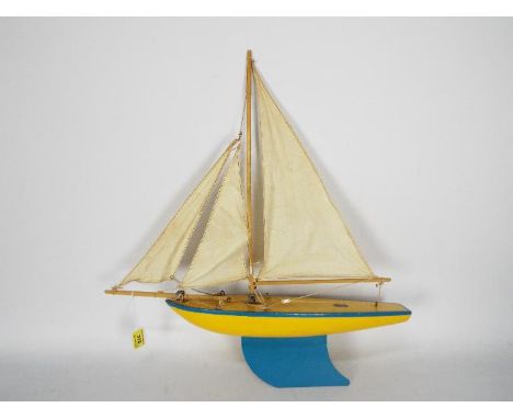 Star - A vintage Star of Birkenhead Pond Yacht in yellow with blue trim with its original sails. The yacht appears in Very Go