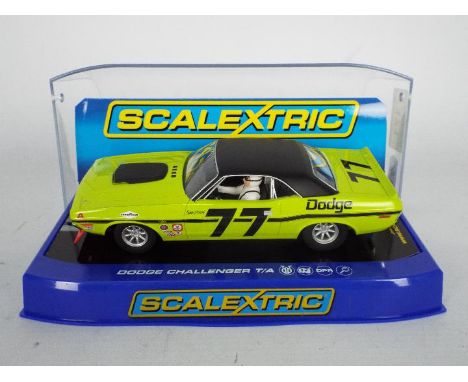 Scalextric - A boxed 1:32 scale 1970 Dodge Challenger T/A in classic Lime green as driven by Sam Posey # C3419. The car appea