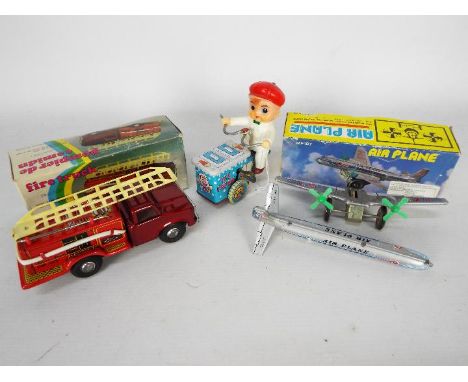 Unbranded - 3 x clockwork toys, an unboxed Japanese made Ice Cream Vendor, a boxed Chinese Fire Truck and a boxed Chinese Air