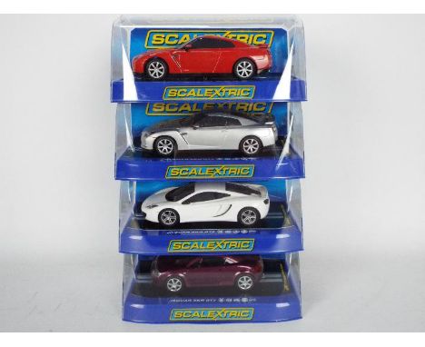 Scalextric - Four boxed Scalextric slot cars all contained within boxes unassociated with the model. Lot consists of a McLare