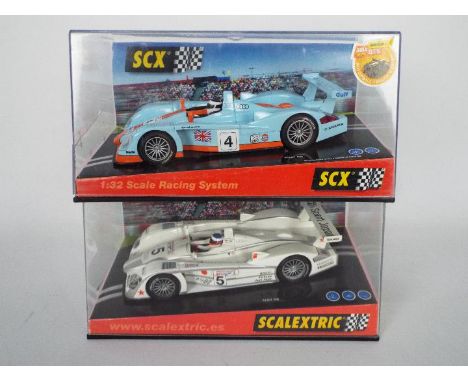Scalextric - SCX - 2 x boxed 1:32 scale Audi R8 race cars, a classic blue and orange Gulf liveried model # 61000 and a white 
