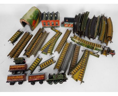 Bing - An unboxed OO gauge Clockwork 2-4-0 steam locomotive and tender (with a key) in green GWR livery, with three unboxed L