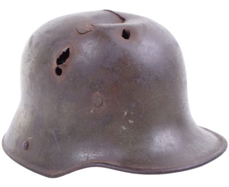 Battle Damaged M.16 Steel Helmet, a ‘66’ size stamped shell, the exterior retaining much of its original field grey green fin