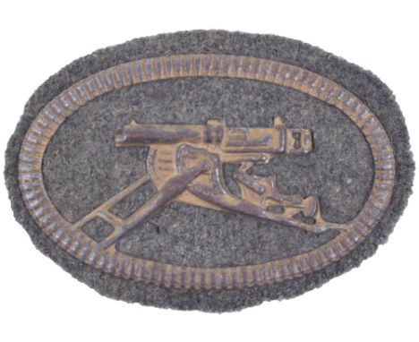 Machine Gunners Qualification Arm Badge, the oval machine gunner’s arm badge measuring 8 x 5.5cms with the stamped metal imag