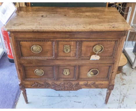 COMMODE, Louis XVI walnut, circa 1780, with two panelled drawers with carved detail and a shaped frieze, 90cm x 47cm x 86cm H