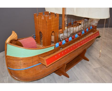 A scratch built model of a Roman ship or quadriremes with single mast, castellated bridge, oars, pikes, shields and drawbridg