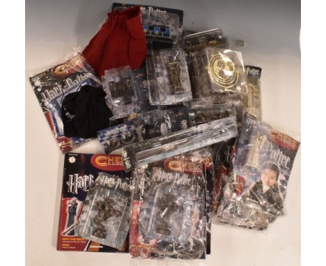 A collection of Harry Potter chess pieces by De Agostini including 35 magazines, magic wand, timer etc.