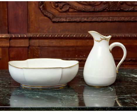 Circa 1760-70The ewer with a meandering vine suspended from the mouth, both with gilt dentil rims, blue interlaced L’s marks 