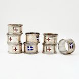 Assembled Set of Eight George V Sterling Silver and Enamel Novelty Napkin Holders