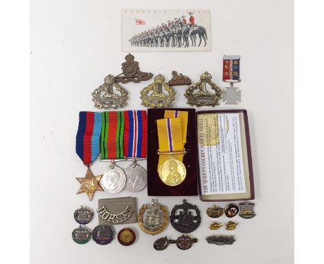 A walking stick, with a Dorset Regiment handle, various Dorset regimental and other badges, and a group of three WWII medals 