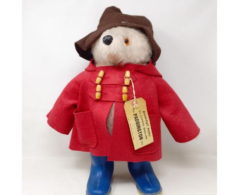 A vintage Paddington bear, with a brown hat and blue wellington boots 