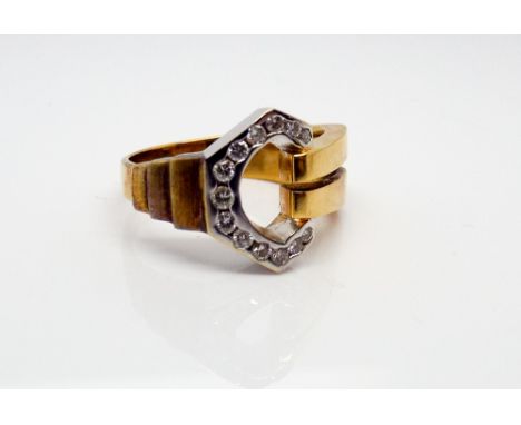 18ct yellow gold and diamond set dress ring, channel set with brilliant cut diamonds in a contemporary buckle design.  Gross 