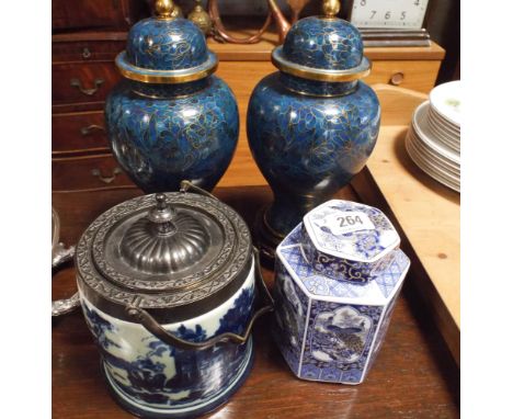 Pair of blue cloisonne jars with covers on hardwood stands, blue and white biscuit barrel and a tea caddy 