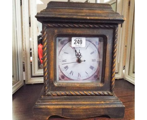 An antique style quartz mantle clock fitted with interior secret drawers