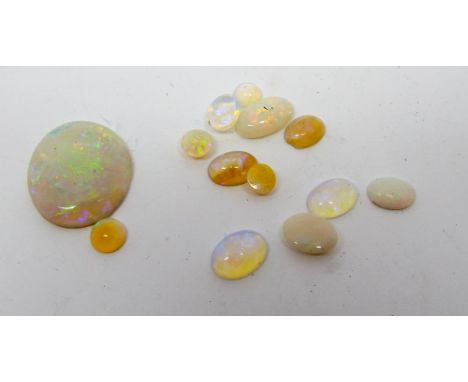 A collection of loose Australian polished opals the largest oval opal measuring 1.7cmsx1.5cms approx with good play of colour