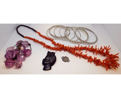 Nine silver bangles, dress ring, stick coral necklace and other items.